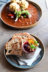 Delicious game pâté served with cranberry sauce and fresh bread in a cozy restaurant setting. A traditional delicacy restaurant food , autumn recipe
