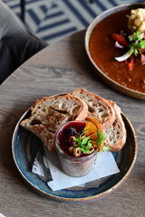 Delicious game pâté served with cranberry sauce and fresh bread in a cozy restaurant setting. A traditional delicacy restaurant food , autumn recipe
