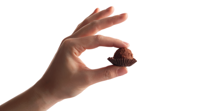 hand holding a single chocolate truffle . Isolated on transparent background, png