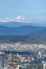 Cityscape view of Tbilisi, the capital of Georgia with snow-capped Caucasus mountains in the distance
