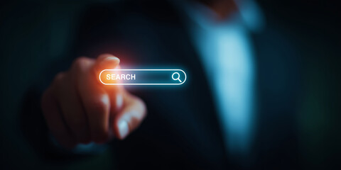 Businessman touching virtual search bar &mdash; futuristic technology concept for SEO, online marketing, digital business, or innovation background.
