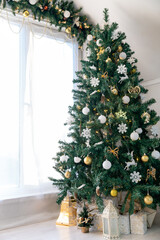Christmas tree in the interior of a bright living room. The attic. Daytime