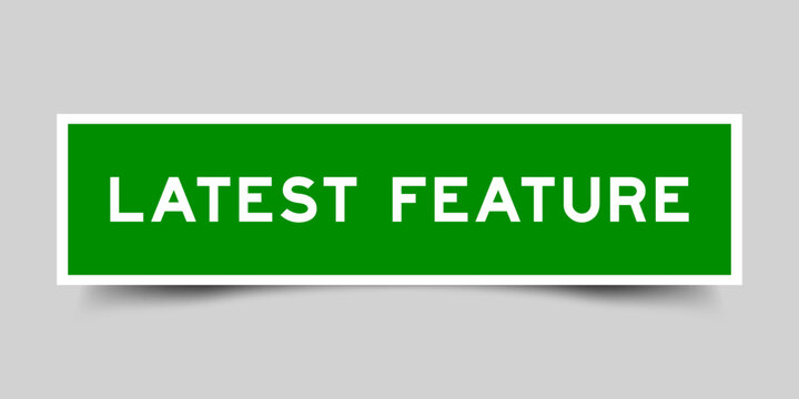 Green color square shape sticker label with word latest feature on gray background