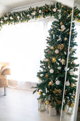 Christmas tree in the interior of a bright living room. The attic. Daytime