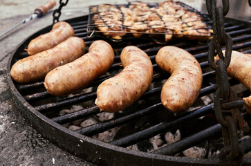 Grilled Sausages Being Cooked Over Charcoal Flames for a Delicious Outdoor Experience