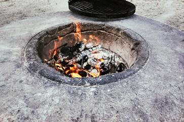 Cozy Campfire nestled in a Stone Pit, surrounded by Glowing Ashes and Dancing Flames