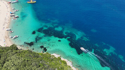 Aerial drone photo of famous steep rocky white cliffs creating beautiful coves and turquiose sea caves of Kampi visited by small boats and yachts in northern part of Zakinthos island, Ionian, Greece