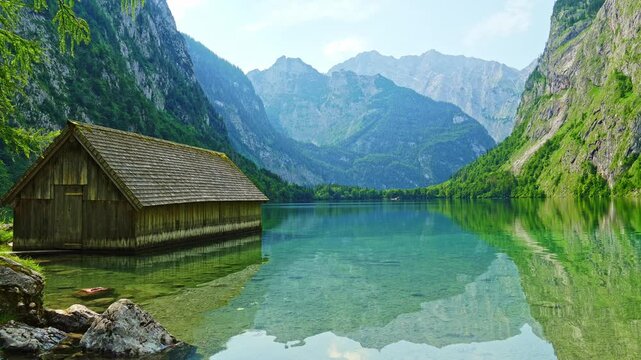 Obersee Lake, Fischunkelalm Wooden Cabin and Mountains on Sunny Day. Ripple and Reflection on Water. Bavaria, Germany