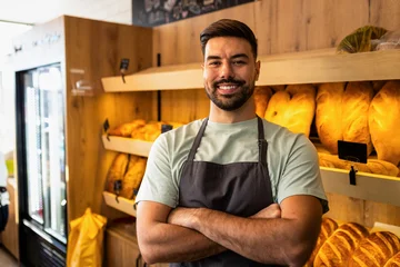 Gordijnen Bakkerij Portrait of smailing male baker standing in bakery looking at camera.  © Zoran Zeremski