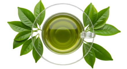 Overhead view of green tea in a glass cup surrounded by fresh leaves