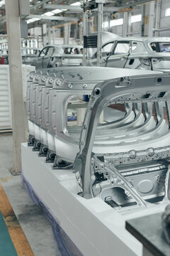 Batch of Unpainted Metal Car Hoods Ready for car Assembly in the Welding Shop of car Assembly Plant