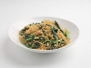 Fried rice noodles and vegetables on wooden background