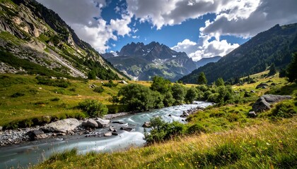 Obraz premium Valley with a river meandering through green grass, lush mountains and a dramatic sky with fluffy clouds