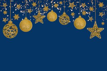 Christmas blue background with Christmas tree decorations with a golden snowflake, star and ball and golden lights with copy space. New Year and Christmas card.