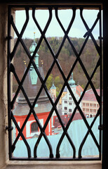 View at the well preserved historic town center of Loket through barred window of the casttle, Czech Republic