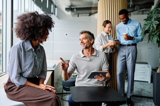 Portrait of a smart young businessman using a tablet computer in the office or classroom. Startup and succesful business concept or education and student concept