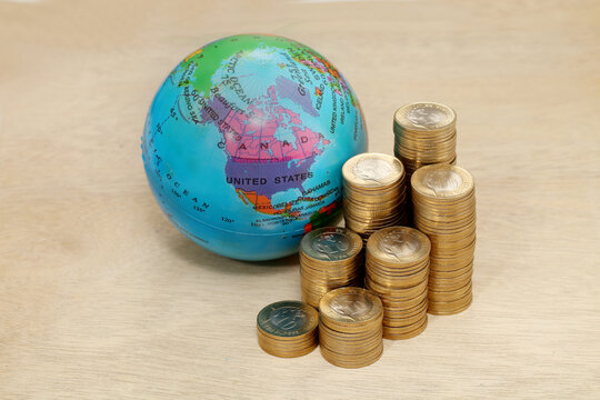 Stack of coin towers and globe - Concept of money investment and growth