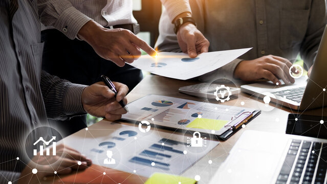 Business experts hands reviewing market data and financial reports charts on laptop for strategic planning. Team collaboration in modern office setting.