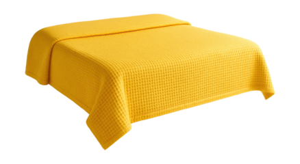 A cheerful yellow waffle-textured bedspread perfect for a small guest room.