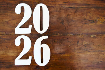 New year 2026 alphabet letter on a brown wood. happy new years copy space concept
