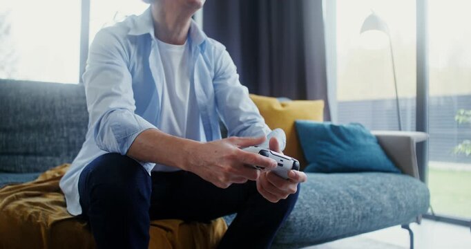 Gray-haired man emotionally playing a video game using joysticks