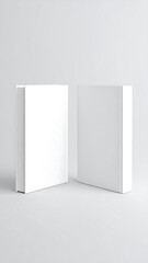 Two blank white books on a light gray background