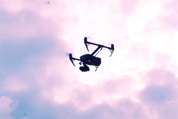 Professional drone shilquotte flying from sky