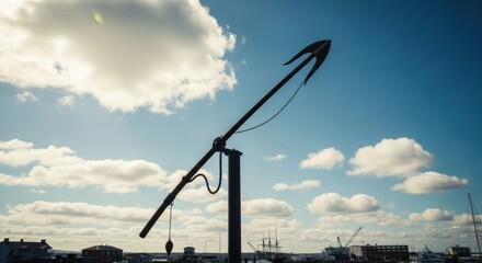 An antiquated spear stands against a blue sky with puffy clouds