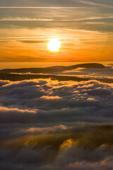 Fototapeta premium Atmospheric mountain landscape with a spectacular cloud inversion at sunset