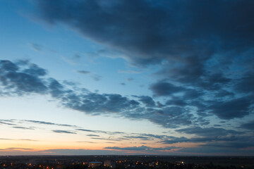 Colorful sunset. Clouds in the evening sky. View from the roof of a multistory building. Lutsk, Ukraine

