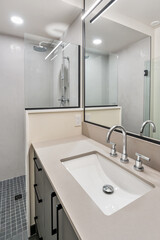 Bathroom with a white sink and a black cabinet