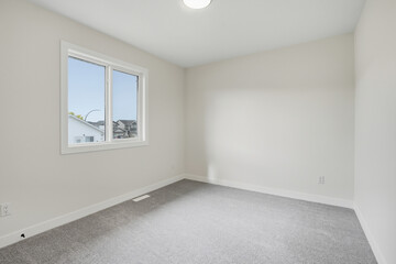 Bedroom with a window and a white wall