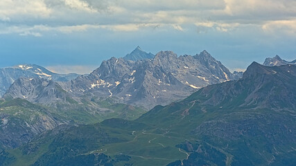 granite mountain peaks with glaciers under a dark stormy sky n La Vanoise national park, Savoie, France 