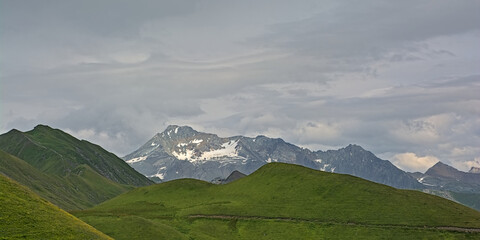 granite mountain peaks with glaciers under a dark stormy sky n La Vanoise national park, Savoie,...