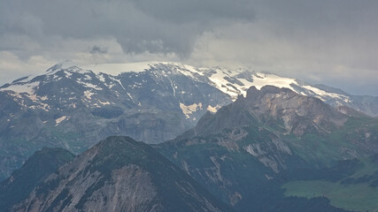 Fototapeta premium granite mountain peaks with glaciers under a dark stormy sky n La Vanoise national park, Savoie, France 