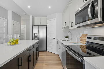 Kitchen with a white counter and a silver refrigerator