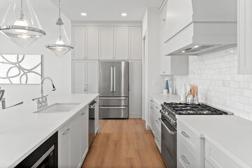 Kitchen with a white counter and a stainless steel refrigerator
