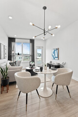 White room with a black and white painting on the wall