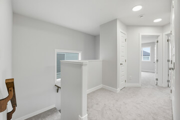 White room with a staircase and a window