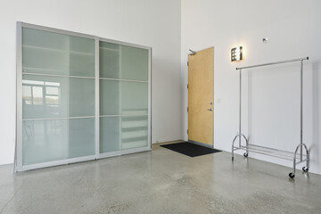 White room with a white door and a white closet