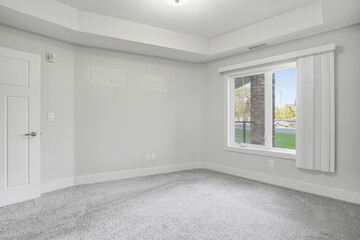 White room with a window and a door