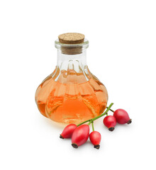 Rosehip vegetable oil in glass bottle with fresh fruits isolated on white background. Natural medicinal and cosmetic product for regeneration and wound healing.