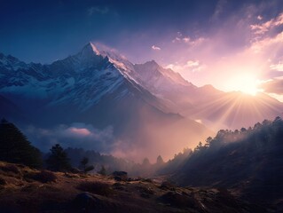 Dramatic sunrise illuminates misty snow capped mountains and pine forest valleys with golden light rays