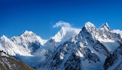 Fototapeta premium Sharp Snow Capped Mountains At High Altitude Against The Background Of Blue Sky
