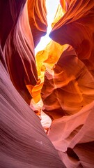 Eroded sandstone slot canyon, with light filtering through the top