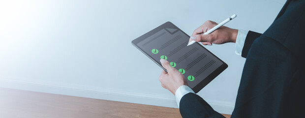 Business man using digital tablet with checklist for task management, productivity, and project...