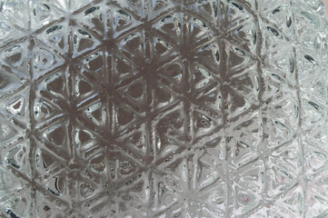 Thick glass wall with triangular texture, abstract background