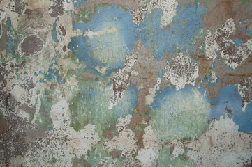 Old weathered gray concrete wall with blue and green paint stains. Abstract textured surface background.