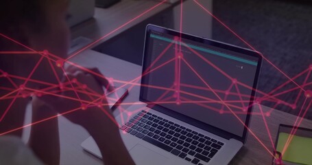 Leaning mid-adult Hispanic woman studying code on laptop at wooden desk, with tablet, copy space