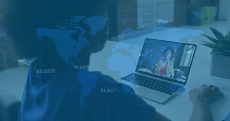 Blue-shirted woman joining meeting using laptop at office desk under world map overlay, copy space